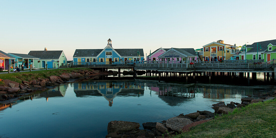 'Colourful buildings in Spinnakers Landing reflected in tranquil water; Summerside, Prince Edward Island, Canada'