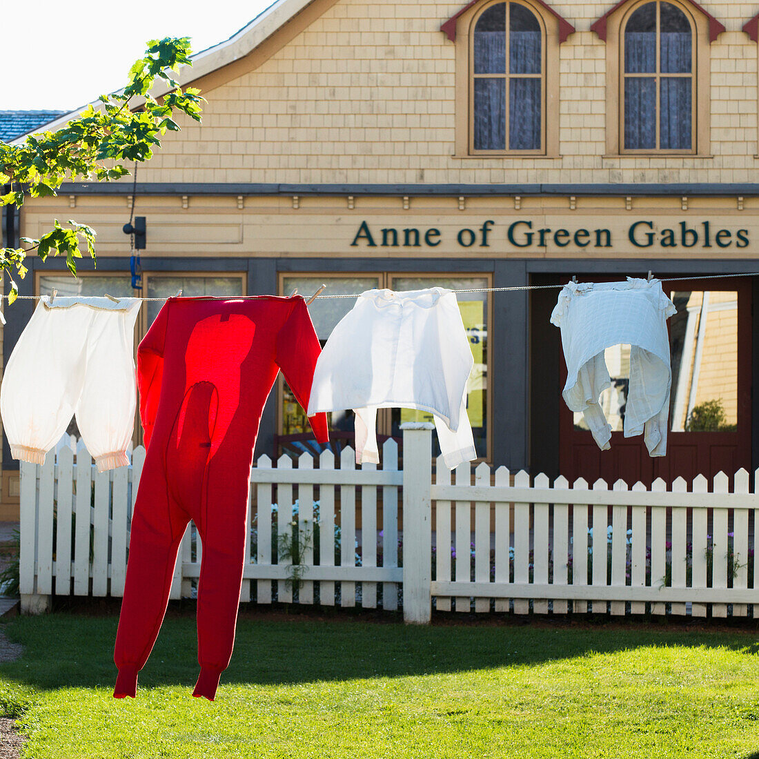 'Clothing hanging on the clothesline in front of a building with an Anne of Green Gables sign; Green Gables, Prince Edward Island, Canada'