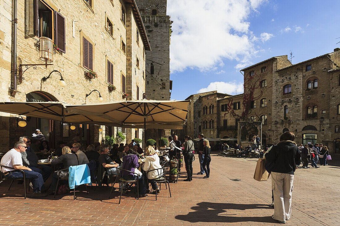 'People in the town square; San Gimignano, Tuscany, Italy'