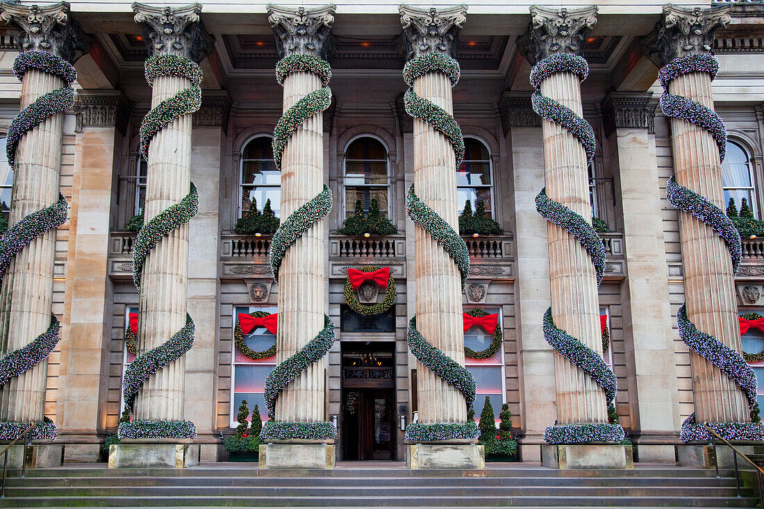 'A building with columns decorated with garland and wreaths at Christmas; Edinburgh, Scotland'