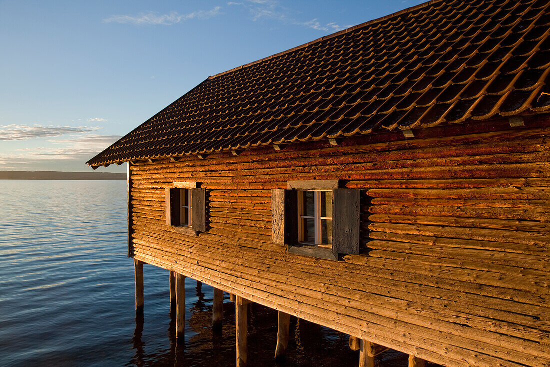 'A wooden building raised on pilings in a lake; Herrsching, Bavaria, Germany'