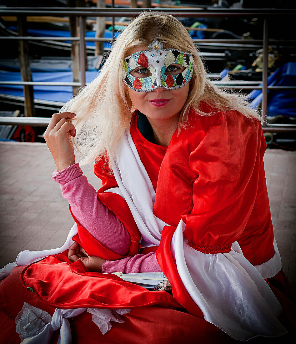 'A girl wearing a colourful eye mask; Venice, Italy'