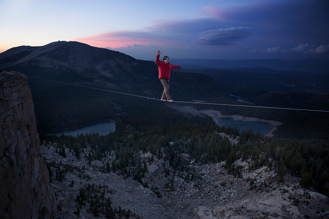 Male highliner walks a 125 foot highline over lakes in a gap on top of Mammoth Crest