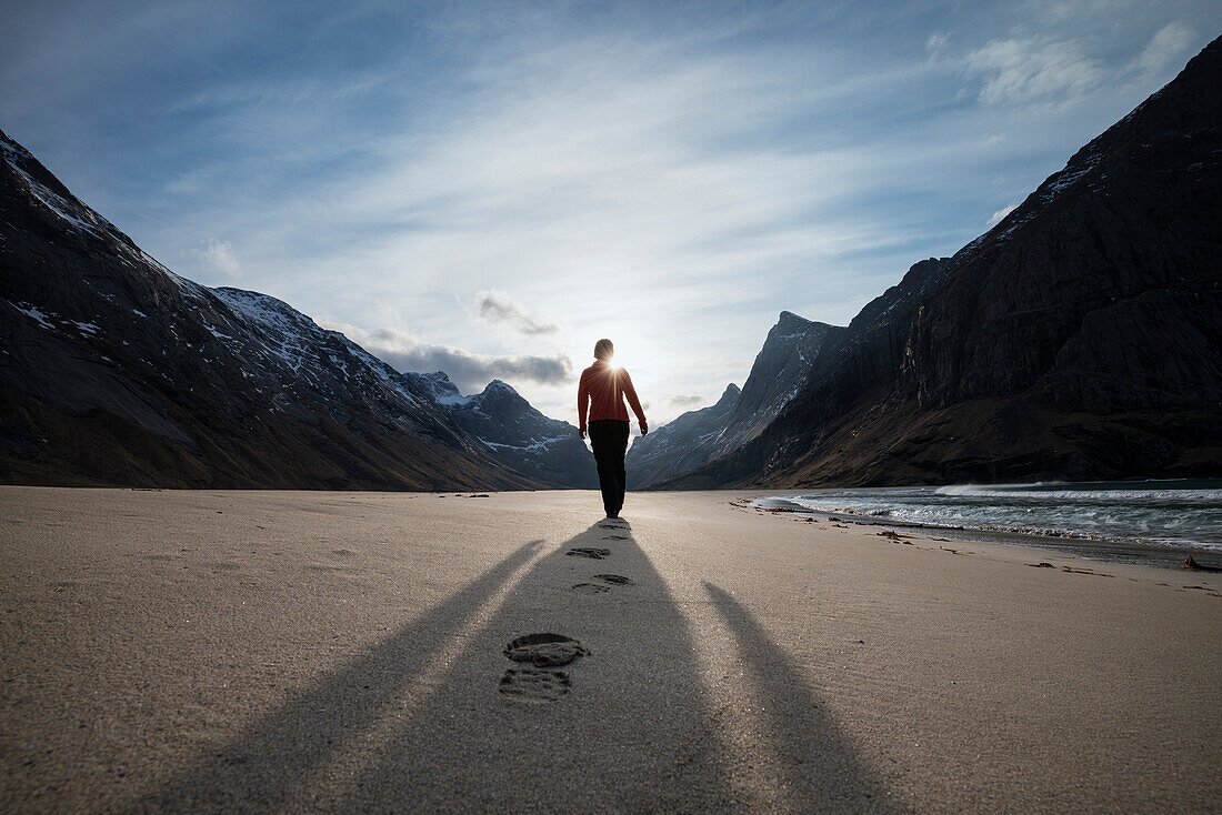 Female hiker leaves footprints in sand on scenic Horseid beach, Moskenes??y, Lofoten Islands, Norway