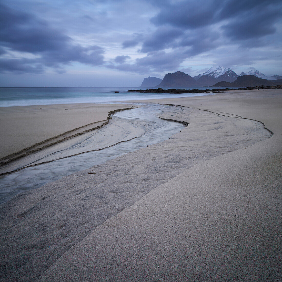 A small river runs through the sand at Storsandnes beach, Flakstad??y, Lofoten Islands, Norway