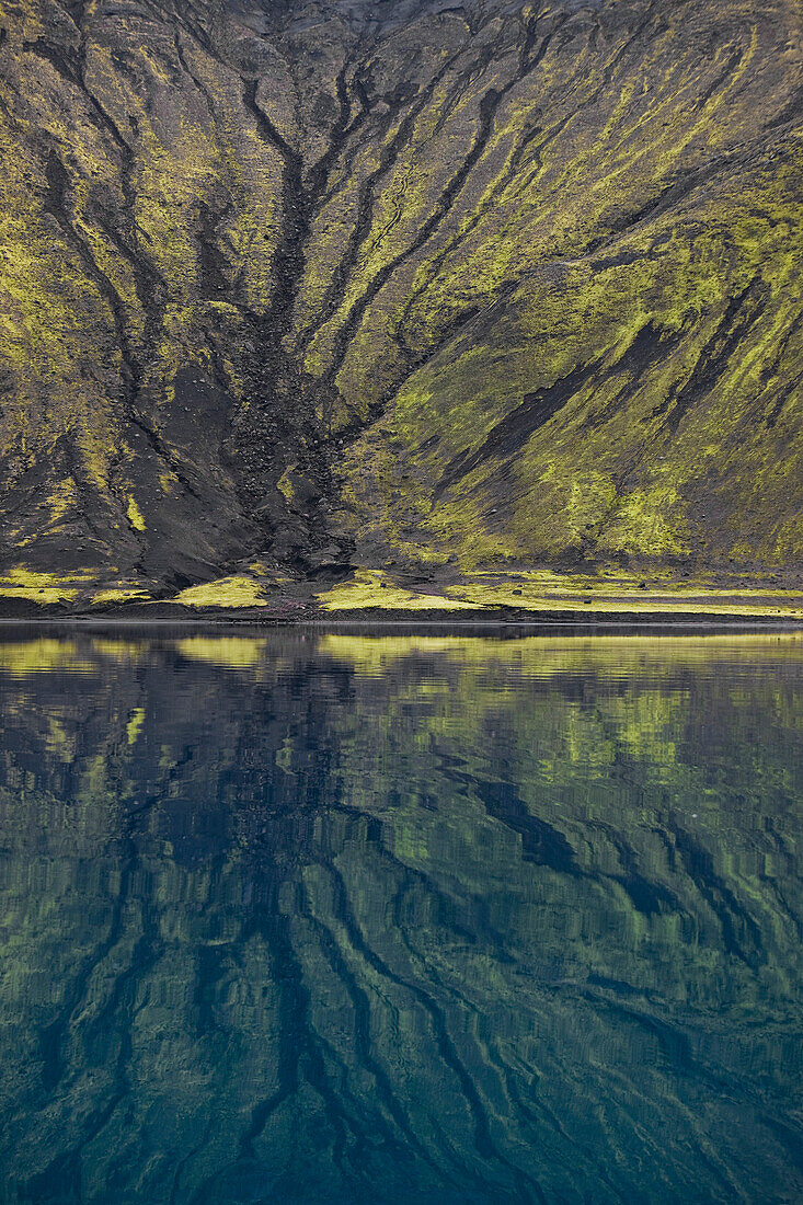 mountain side reflects in the Langasjo river in central Iceland