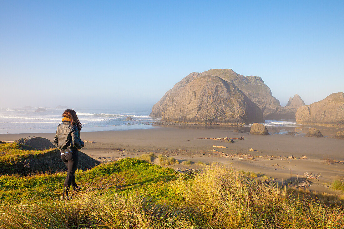 A female tourist approaches Meyers Creek Beach, Pistol River State Park, Oregon.