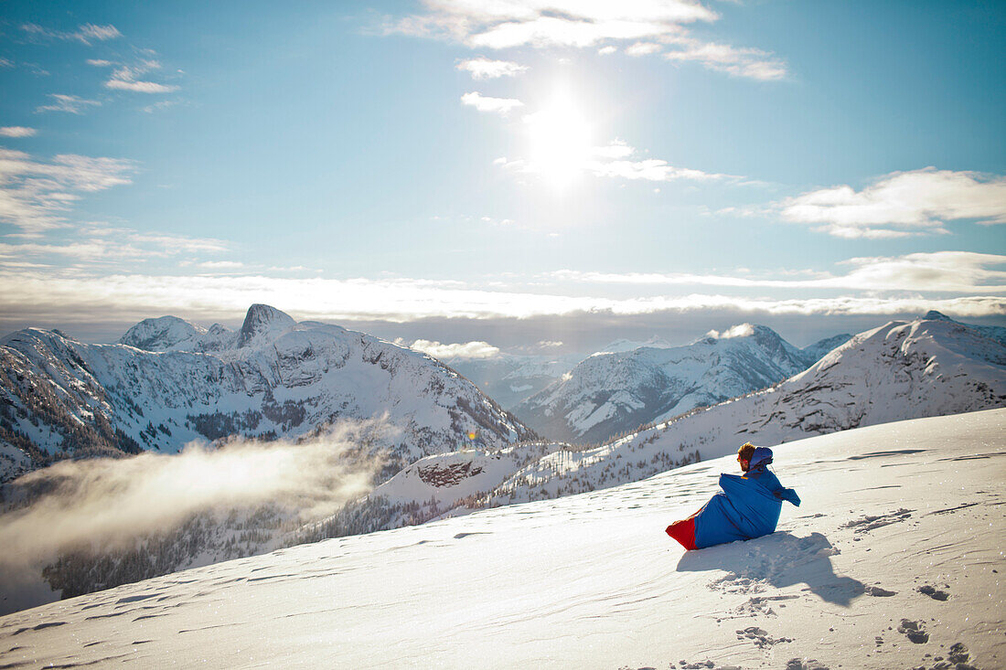 A man wakes up to a winter landscape after a cold night in a bivy sack.