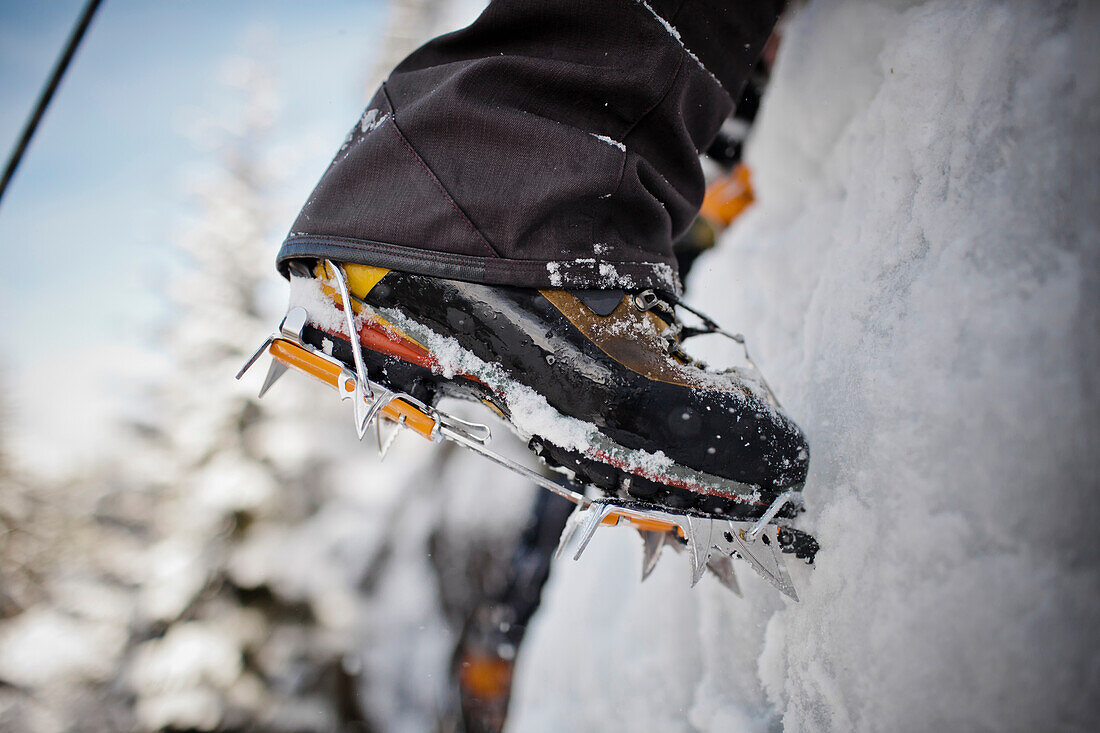 Boots and crampons on an ice wall in Whistler, British Columbia, Canada.