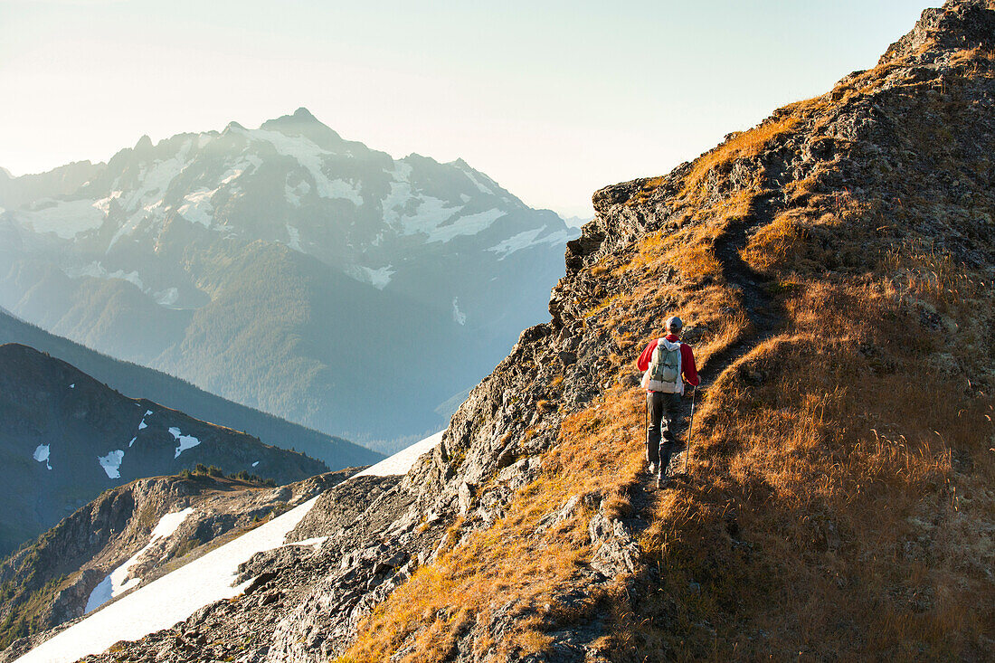 Hiking in the North Cascade Mountains with Mount Shuksan in the background.