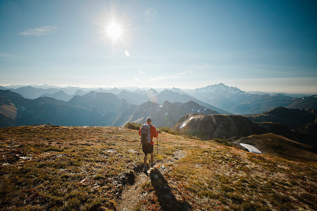 A hiker walks along a trail in North Cascades National Park.