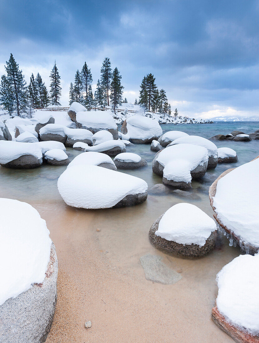 Fresh snow covers bolders at Sand Harbor, Lake Tahoe