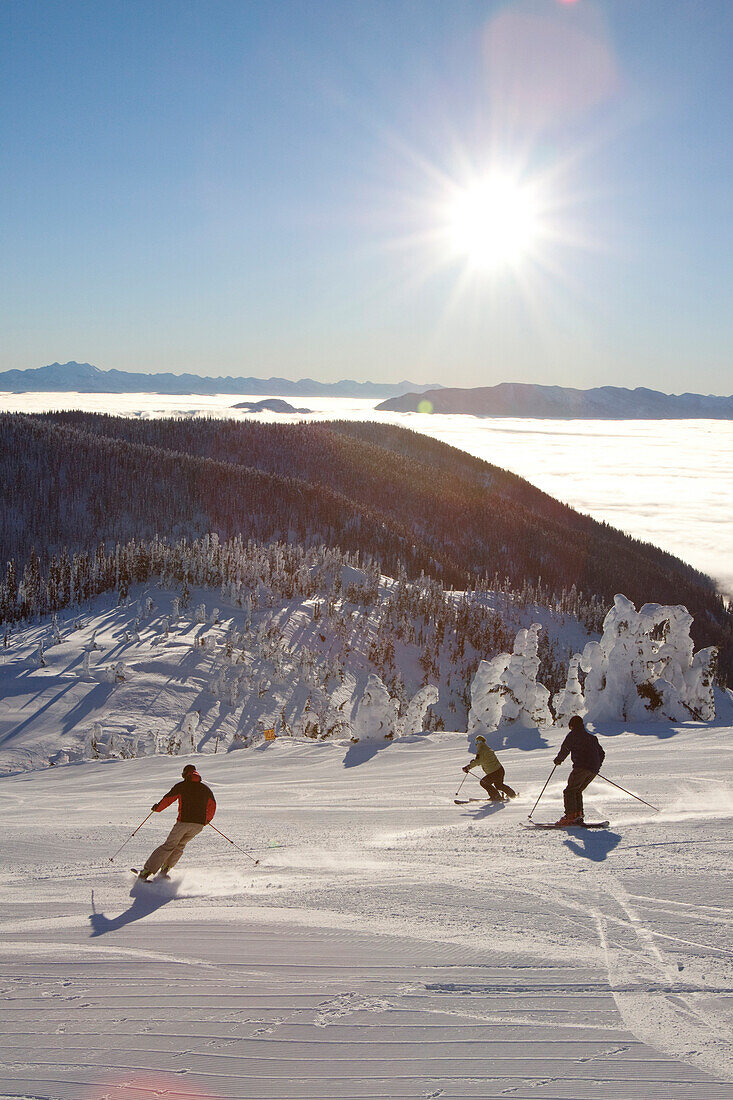 Skiers on fresh groomed slopes in Whitefish, Montana.
