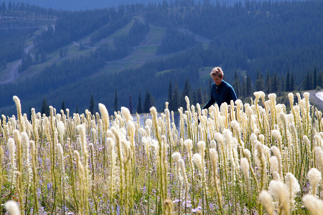 A woman walks through wildflowers in Whitefish, Montana.