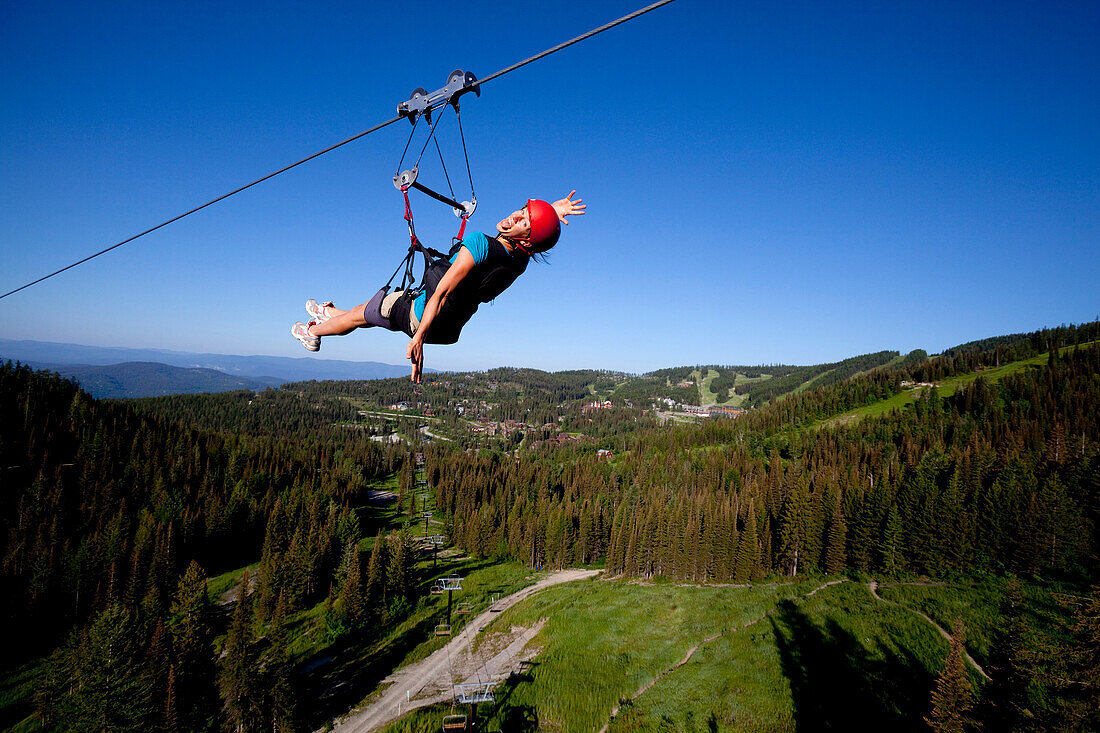 Woman on a zip line smiling