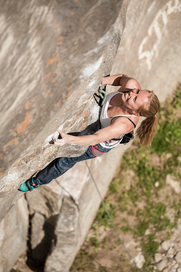 Italian girl  climbs a 7a+ route in Balmanolesca, the most historical granite crag in Ossola, Italy.