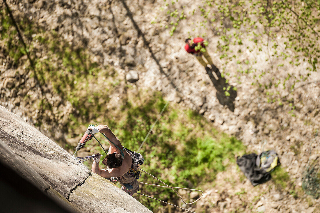 Lucas Iribarren bolting a new route in Premia's crag. Premia, Piemonte, Italy.