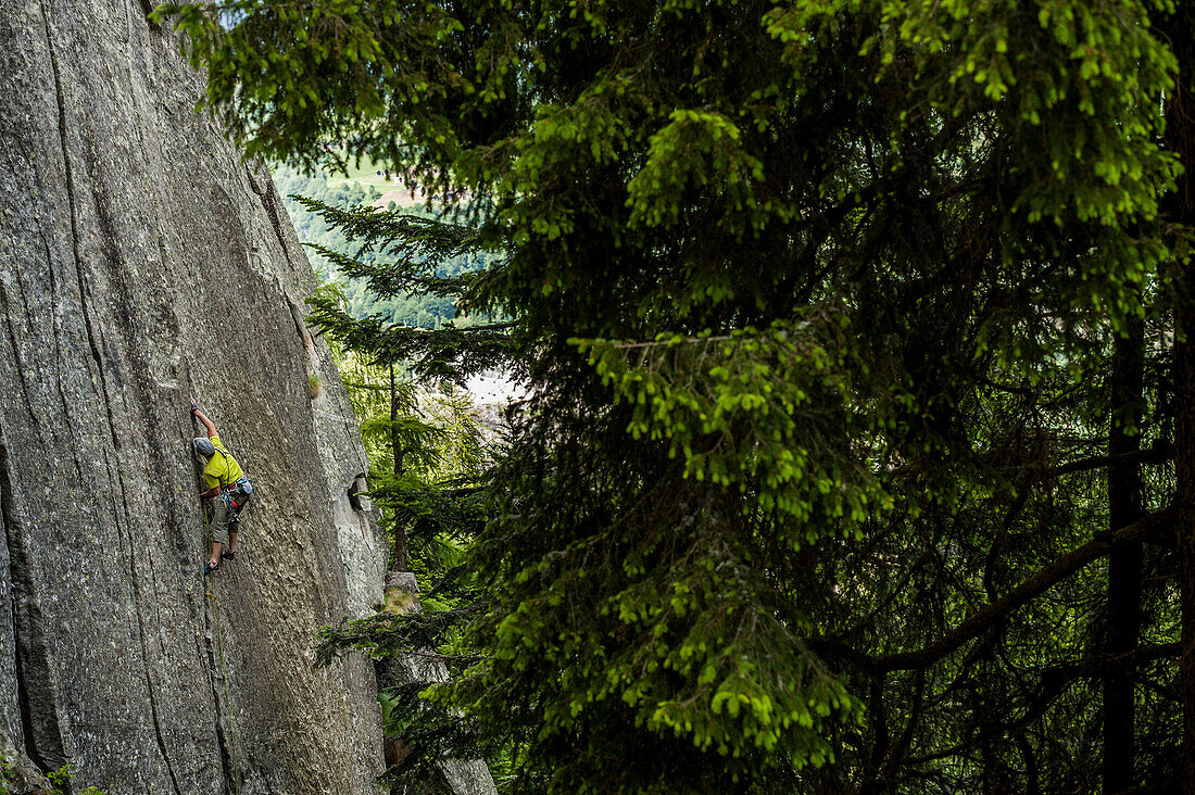 Italian mountaineer and climber trad climbing a crack route in Esigo, Ossola, Italy. Ossola is one of the main destination in Europe for crack climbing.