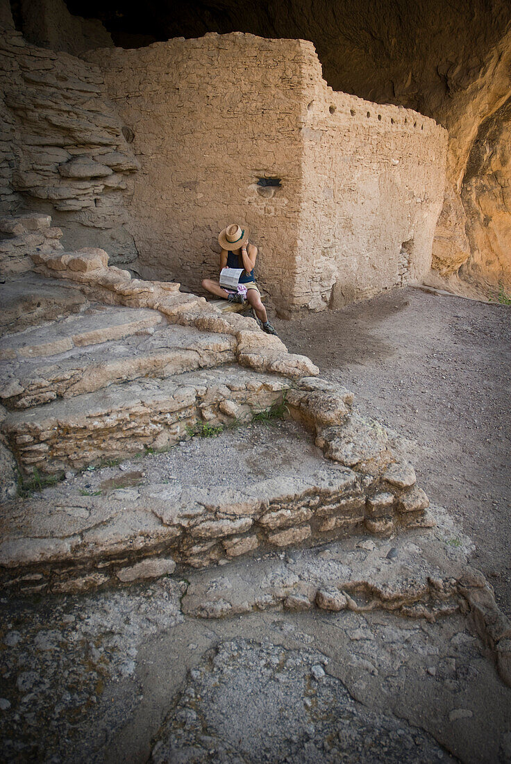 A young woman in her twenties visits Gila Cliff Dwelling National Monument, New Mexico.