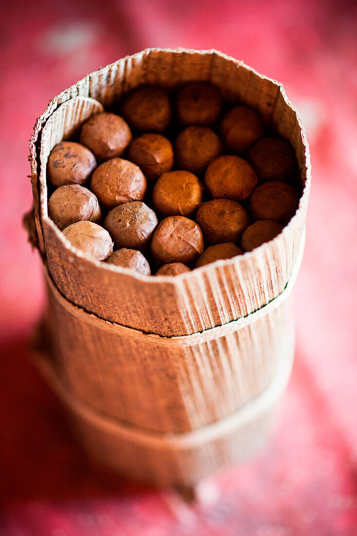 A finished packet of cigars stands on a table in the Vi?±ales valley in Cuba. Cigars are wrapped in banana leaves to keep the cigars from getting too dry.