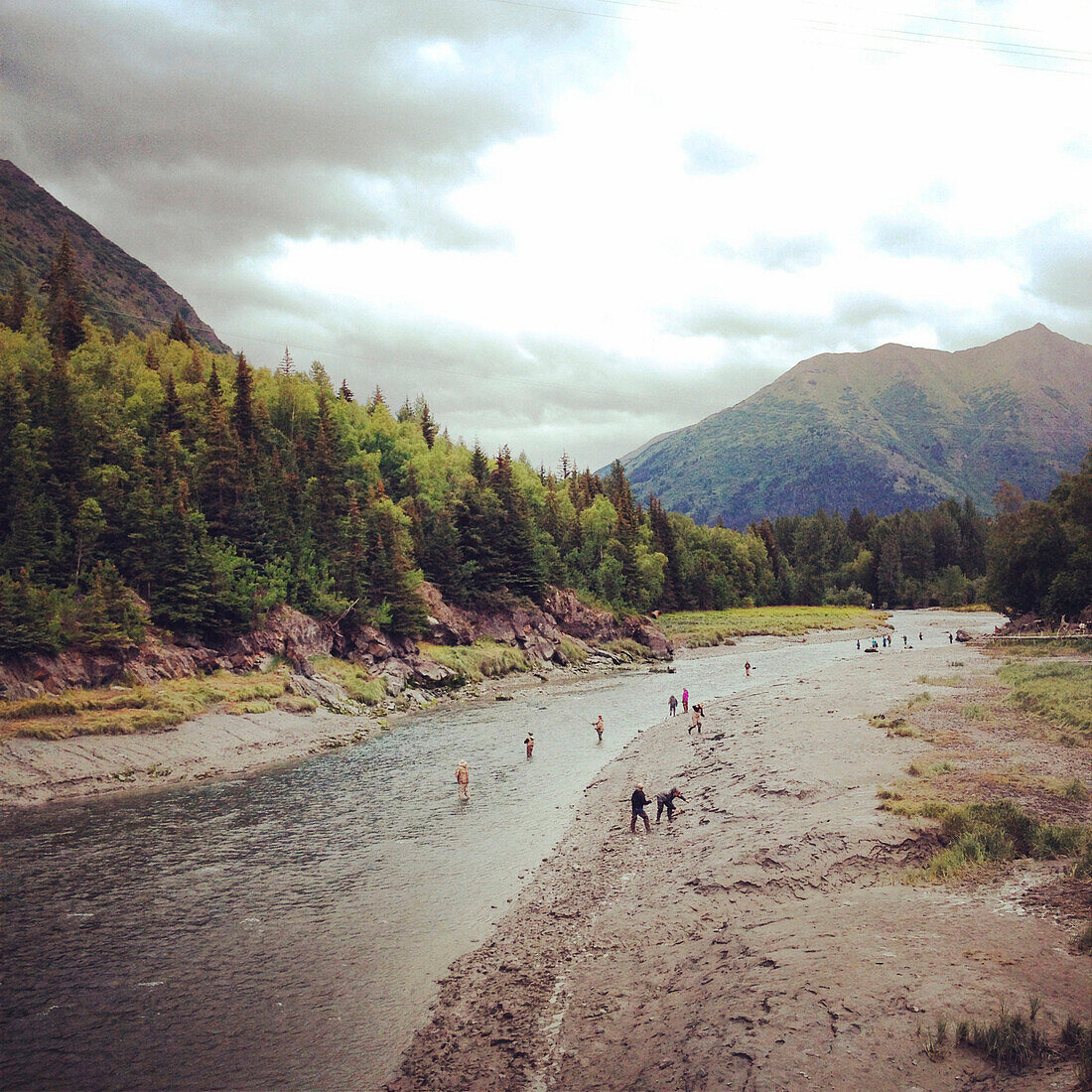 Fly fishing in river near the mountains in Alaska.