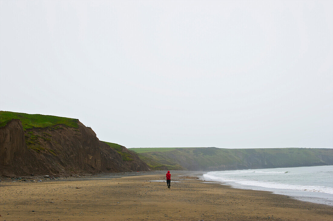 'A man walks alone on a Aberdaron Beach; Wales'