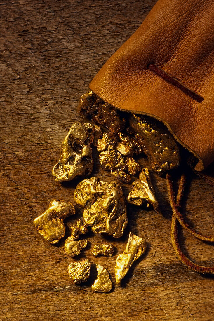 Gold Nuggets spill out of bag onto table