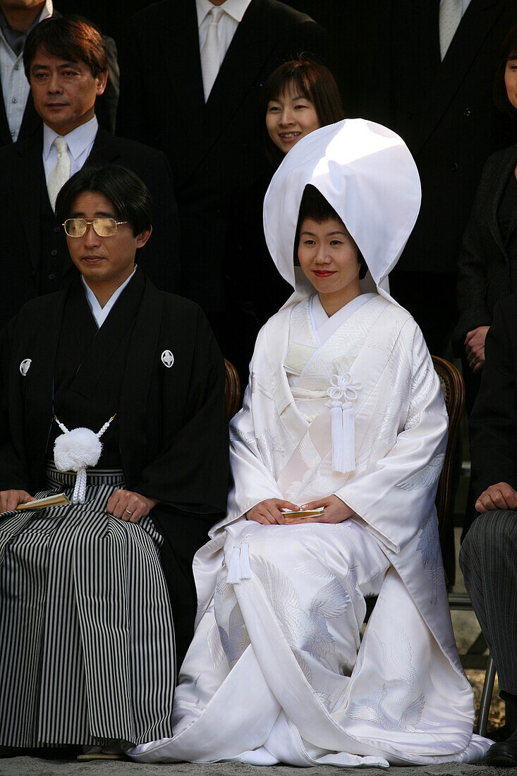 'After The Traditional Japanese Shinto Wedding Ceremony Families Gather For A Formal Portrait Sitting, At Meiji Jingu Shrine; Near Harajuku Station; Tokyo. There Are Several Layers Of The Brides White Kimono And A Silk Brocade Covers All. Traditionally Th