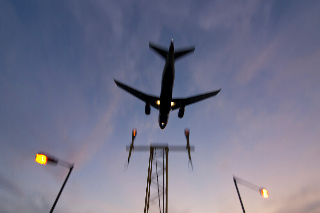 Airplane Approaching At Sunset.