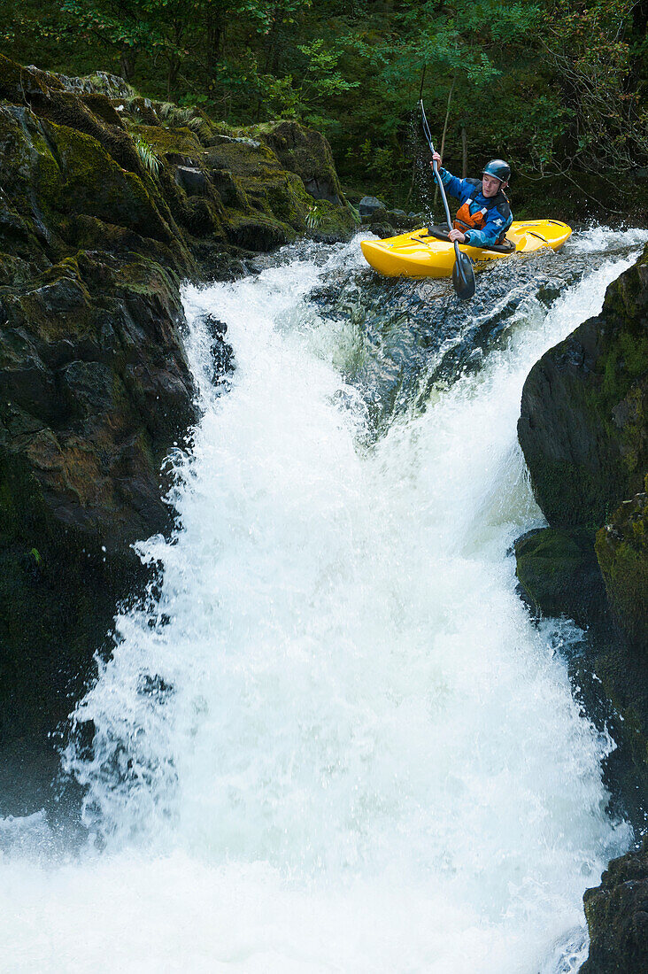 'England, Cumbria, Lake District National Park, Canoeist going down Skelwith Force waterfall; Langdale'