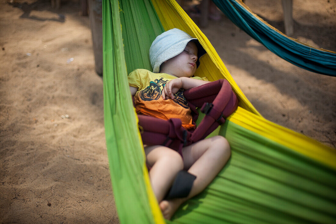 Rudi Mchugh sleeps happily in a hammock on Turtle Beach, Goa, India.