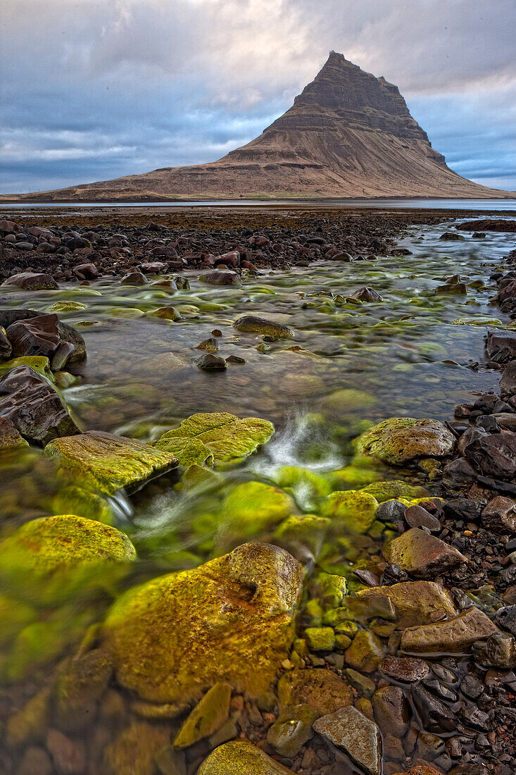 'The mountain Kirkjufell rises above the ocean near town of Grundarfjorour, Snaefellsnes Peninsula; Iceland'