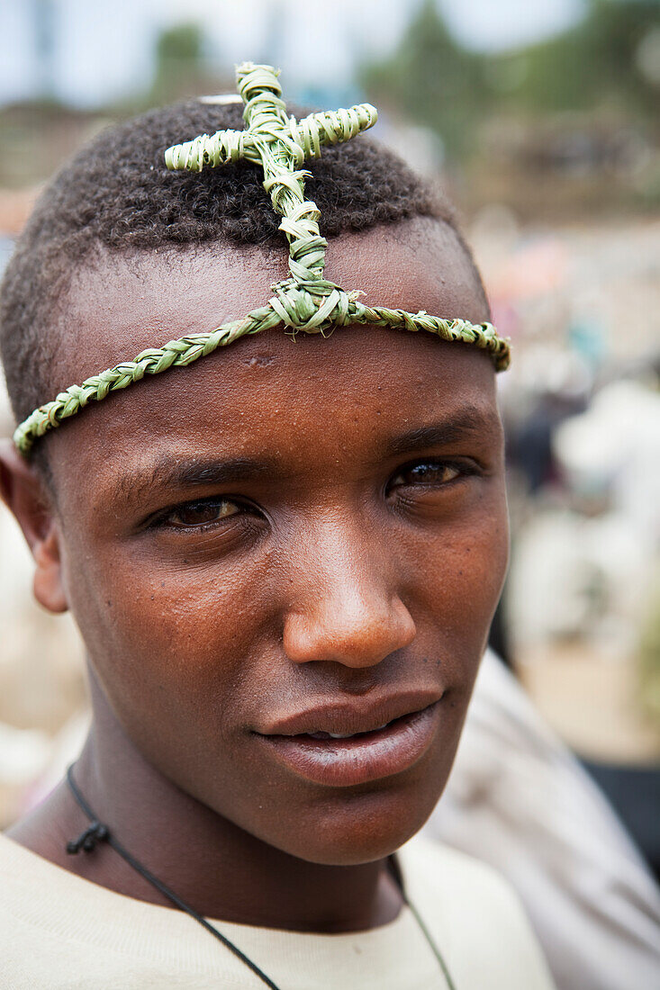 'Boy wearing a traditional grass headband to celebrate Orthodox Easter; Lalibela, Ethiopia'