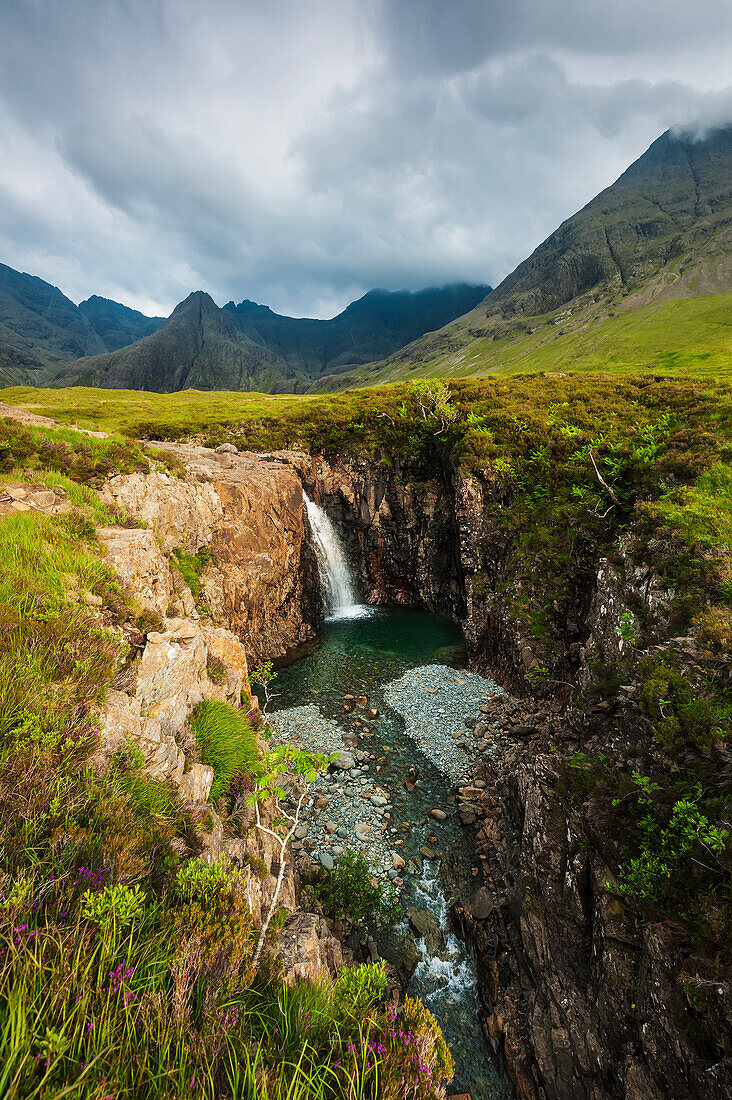 'Waterfall in Coire na Creiche (The Fairy Pools) near Glen Brittle with the hills of the Black Cuillin in the background; Isle of Skye, Scotland'