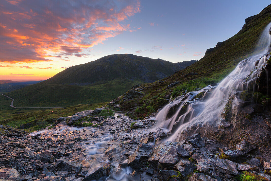 Scenic sunset view of a waterfall at Summit Lake State Recreation Site, Hatcher Pass, Southcentral Alaska, Summer