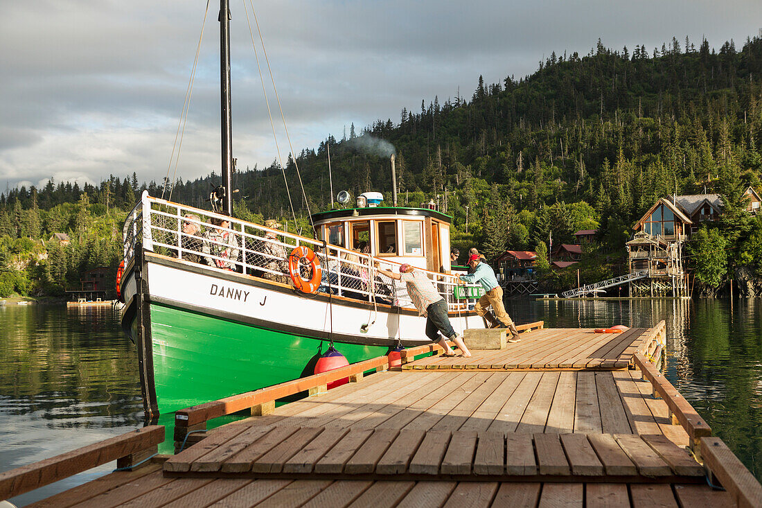 Crew members push off the Danny J to depart from Halibut Cove, Kachemak Bay, Southcentral Alaska