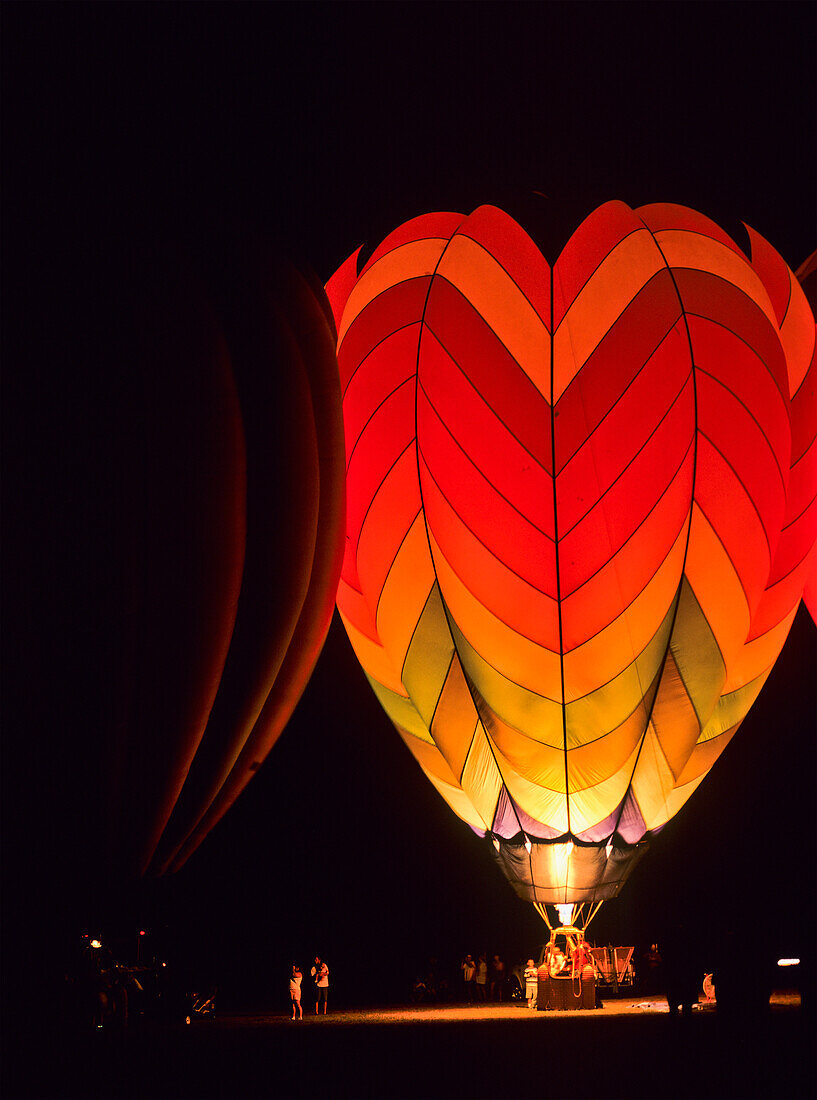 'A hot air balloon illuminated at nighttime; Tahlequah, Oklahoma, United States of America'
