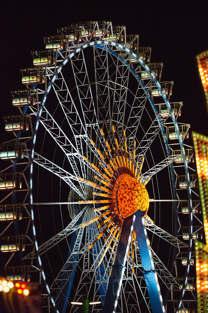 'Ferris wheel illuminated at nighttime; Munich, Germany'