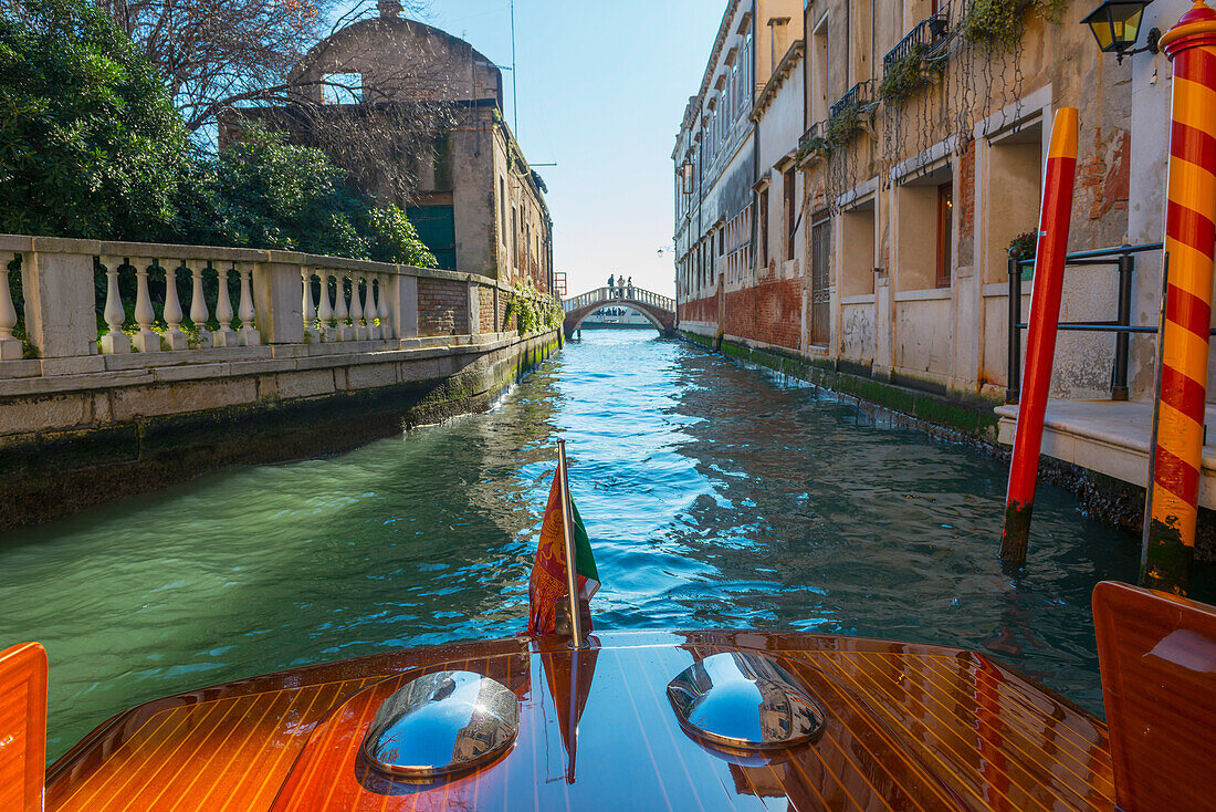 'Buildings along the shoreline of a canal viewed from a boat; Venice, Veneto, Italy'