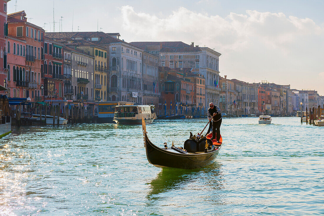 'Gondolier rows in a gondola in the grand canal; Venice, Veneto, Italy'