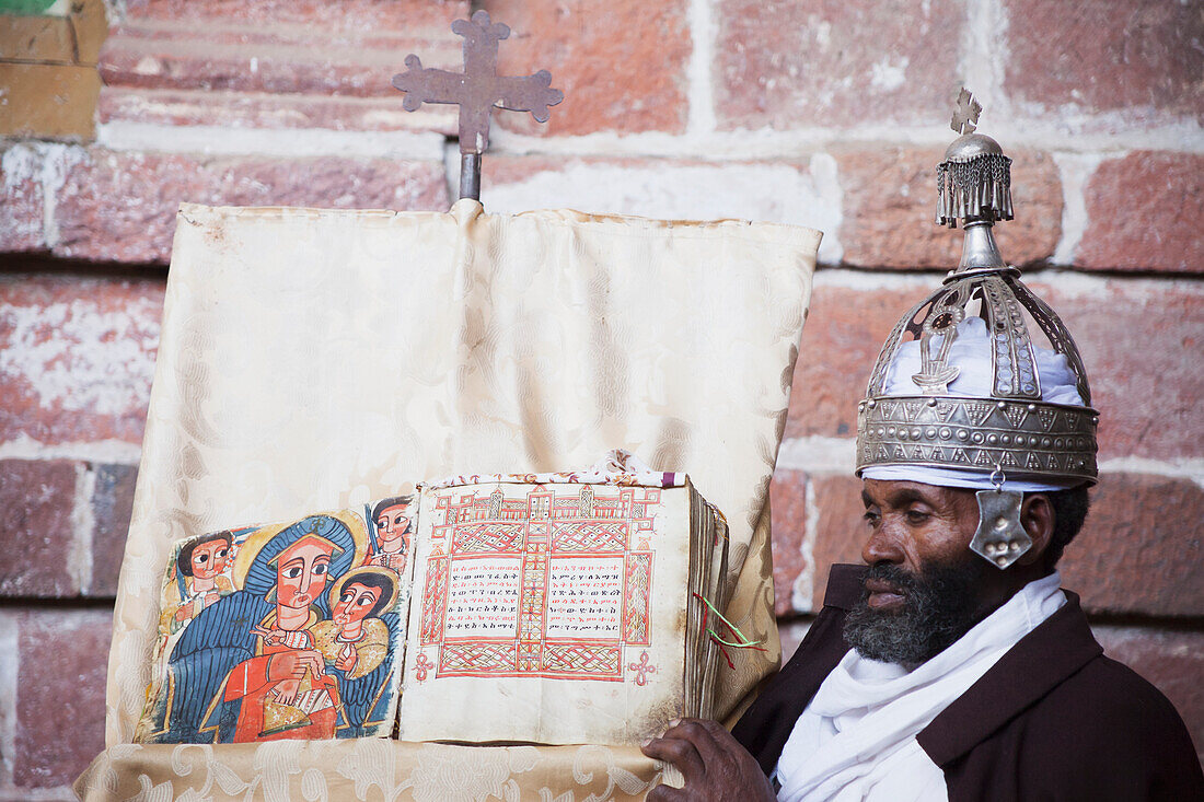 'Priest with crown and holy book, Nakuta Laab monastery, near Lalibela; Amhara region, Ethiopia'