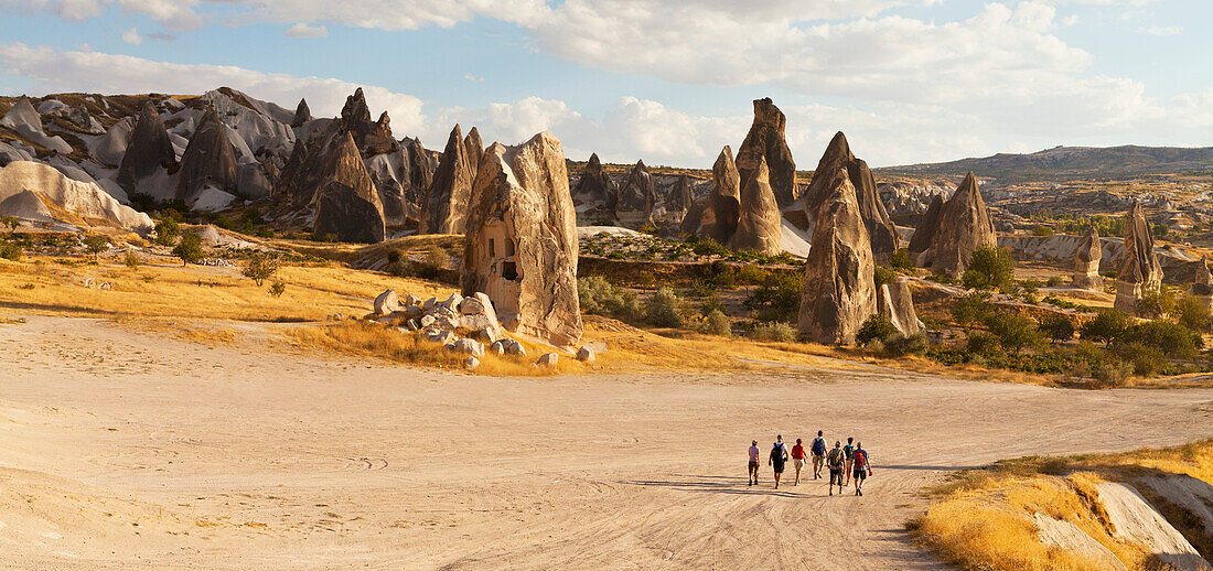 'A tour group walks down a road in Rose Valley; Cappadocia, Turkey'