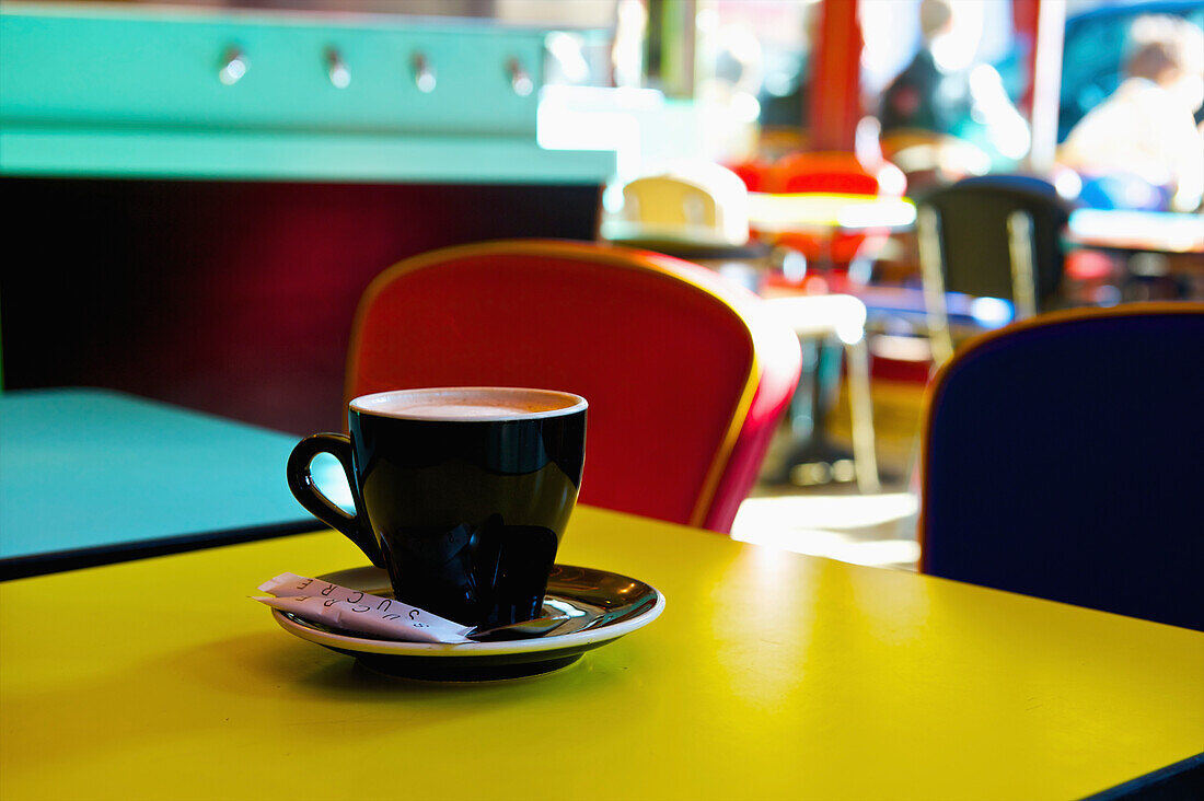 'A cup of coffee in a brightly coloured cafe, Marais district; Paris, France'