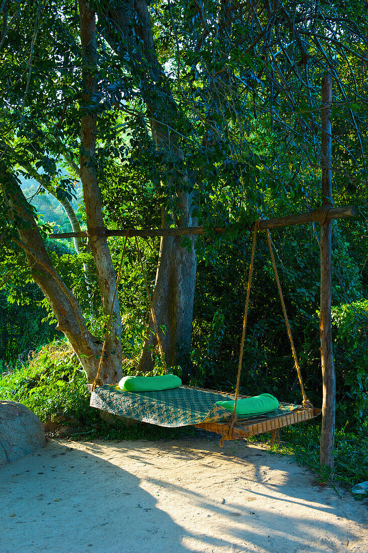 'A hammock hanging beside trees; Ulpotha, Embogama, Sri Lanka'