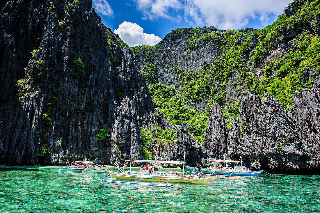 Outrigger boats in the crystal clear water in the Bacuit archipelago, Palawan, Philippines, Southeast Asia, Asia