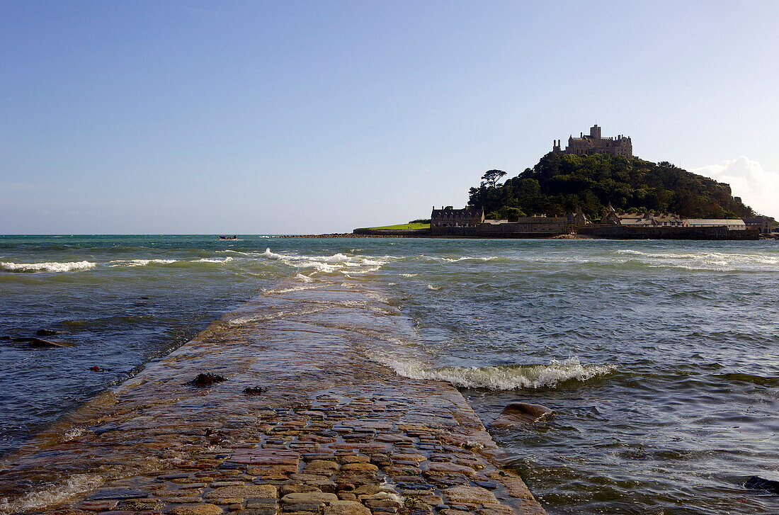 The old stone causeway leading to St. Michaels Mount submerged by the incoming tide cutting it off from Marazion, Cornwall, England, United Kingdom, Europe