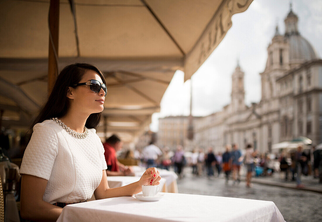 Young woman enjoying Espresso at restaurant, Piazza Navona, Rome, Italy, Europe