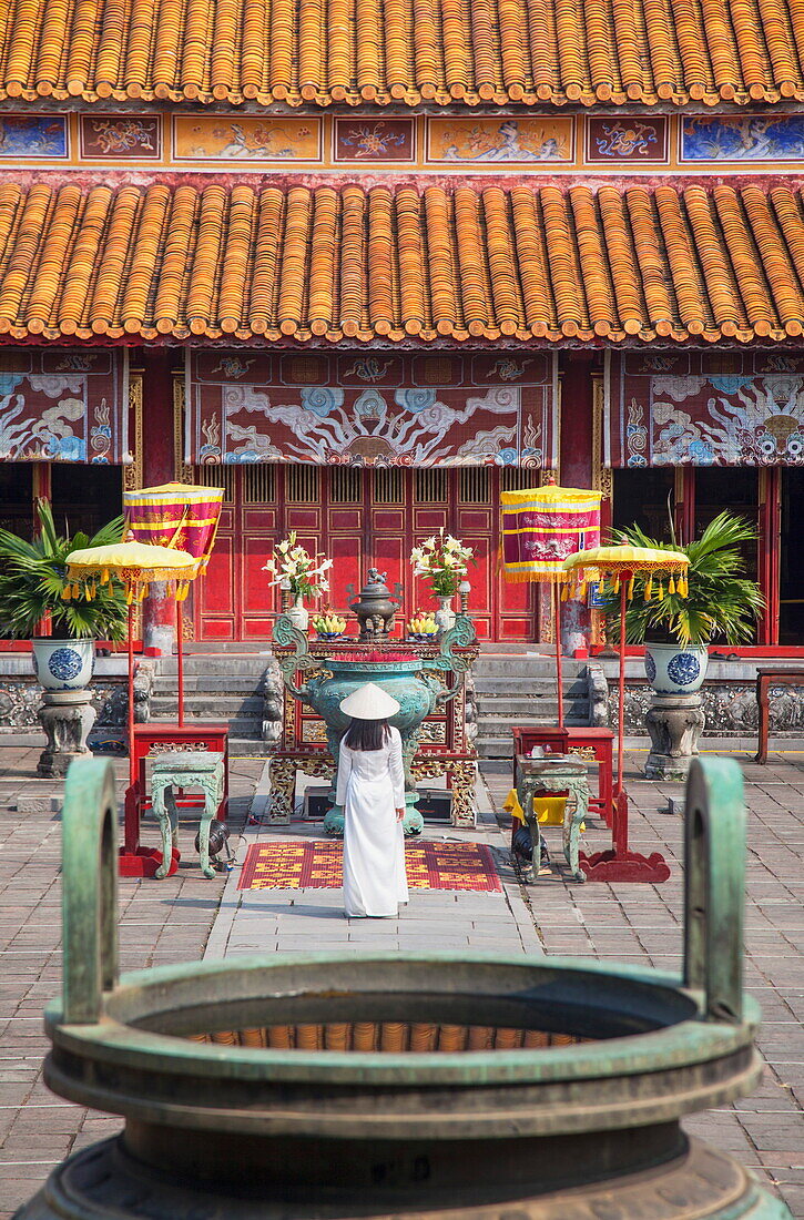 Woman wearing Ao Dai dress at Mieu Temple inside Citadel, Hue, Thua Thien-Hue, Vietnam, Indochina, Southeast Asia, Asia
