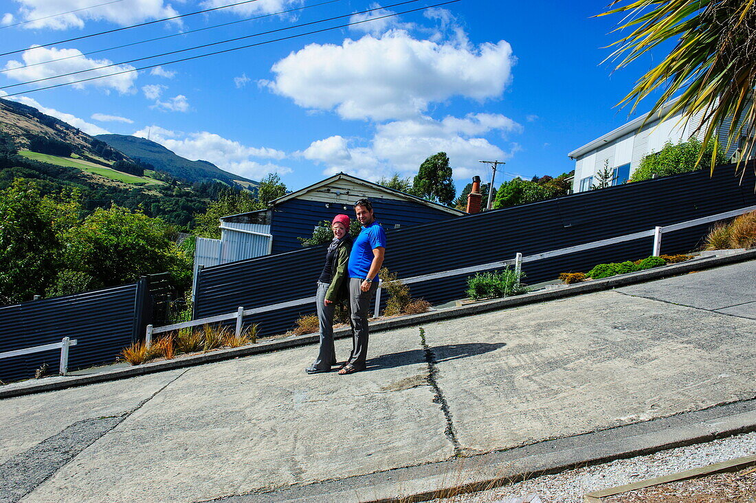 Tourists standing on Baldwin Street, the world's steepest residential street, Dunedin, Otago, South Island, New Zealand, Pacific