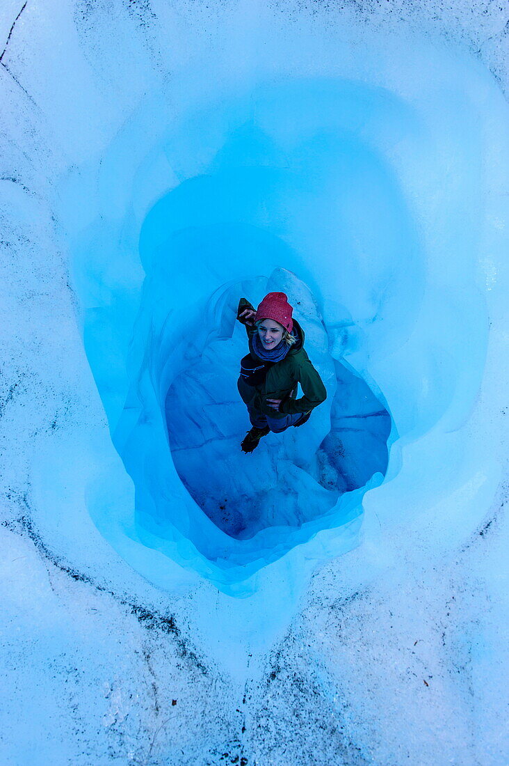 Woman standing in an Ice cave in the Fox Glacier, Westland Tai Poutini National Park, South Island, New Zealand, Pacific